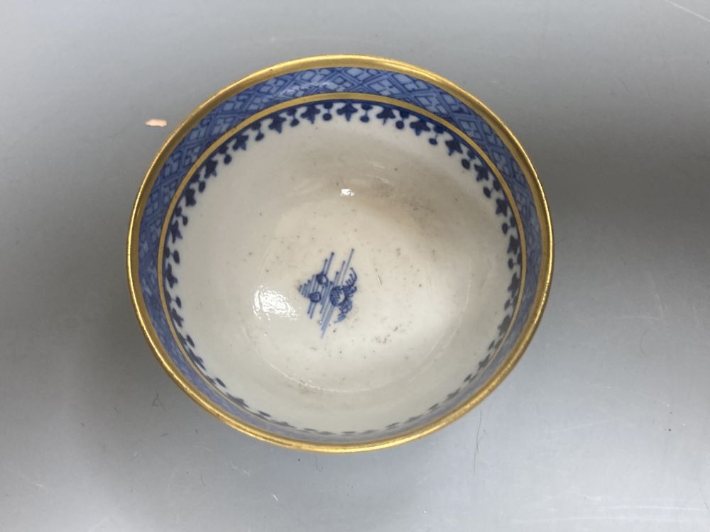 An 18th century English blue and white tea bowl and three smaller Chinese ceramic cups, two marks